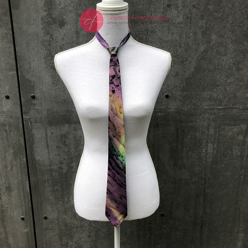 A tie made of blue, green, and purple silk chiffon, lined with taupe ramie.