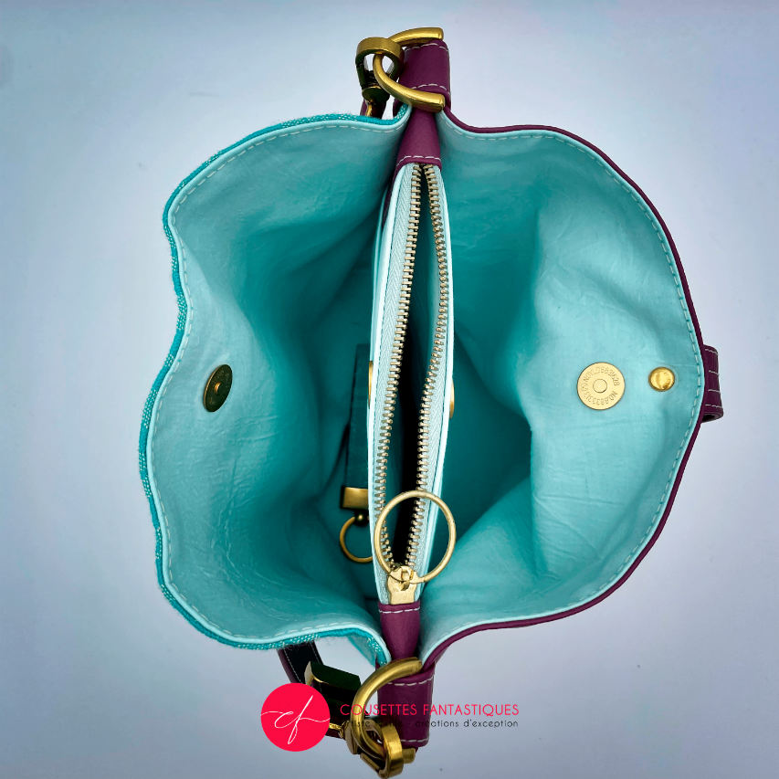 Un sac d'épaule en tissu d'écharpe turquoise et écru à motif de feuilles, simili prune et popeline menthe irisée.