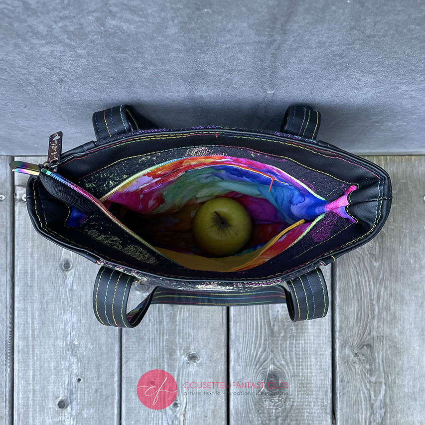 Two-tone/two-material handles, luxury rainbow-colored hardware, velvety upcycled synthetic leather, and a playful babywearing fabric coupon with a whimsical pattern.